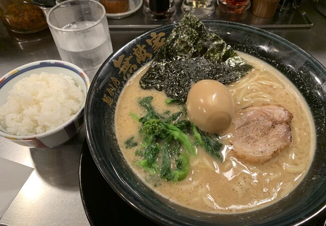 A Mutekiya tonkotsu ramen with a side of rice — creamy pork-bone broth, char siu, a soft egg, spinach and branded nori