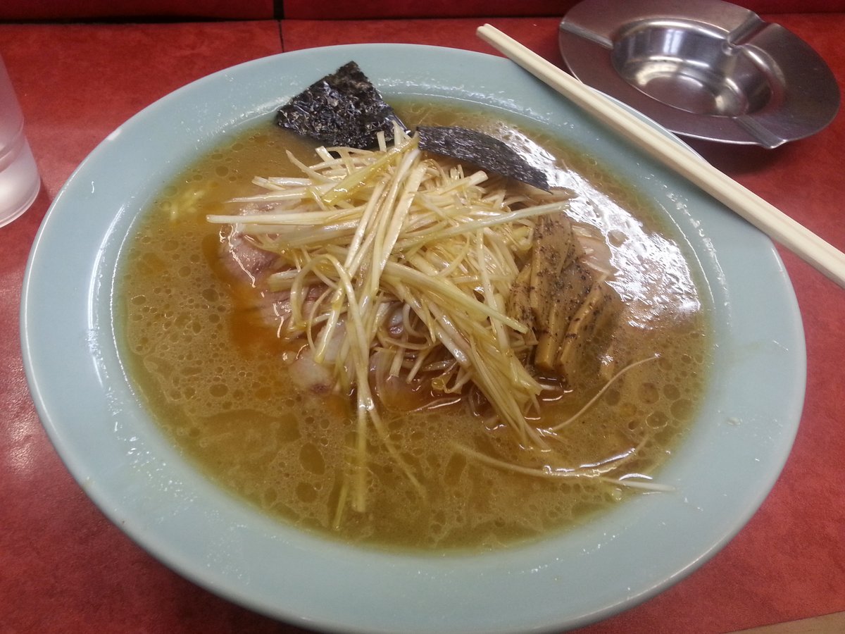 A bowl of Ramen Shop negi-chashu ramen — soy-tonkotsu broth heaped with sesame-dressed green onion and slices of char siu pork