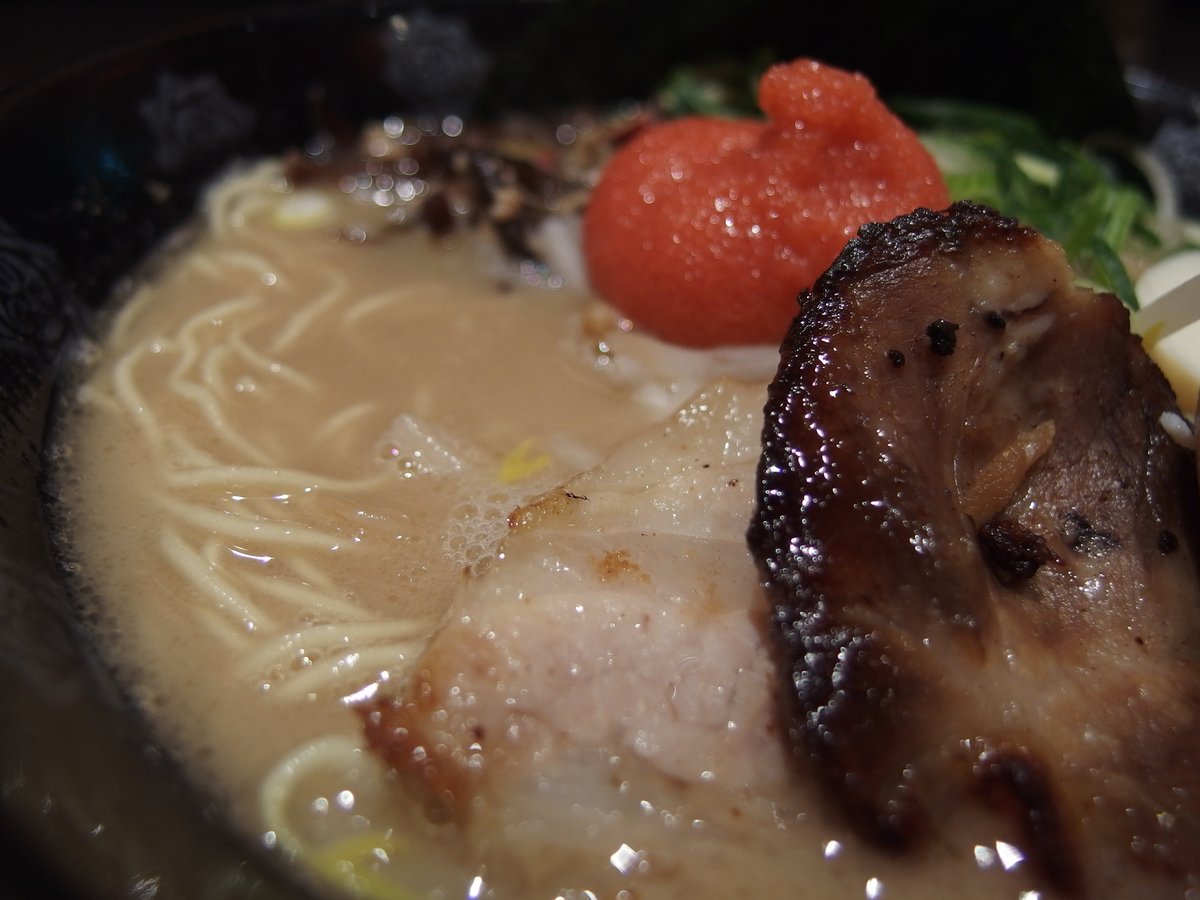 A close-up of rich tonkotsu ramen with seared char siu pork, kikurage mushroom and thin noodles