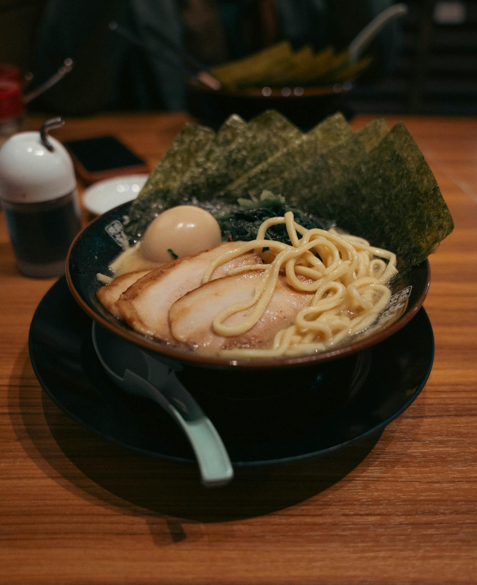 A steaming bowl of Tokyo ramen with chashu, nori and a soft egg — a cheap local meal under 1,000 yen