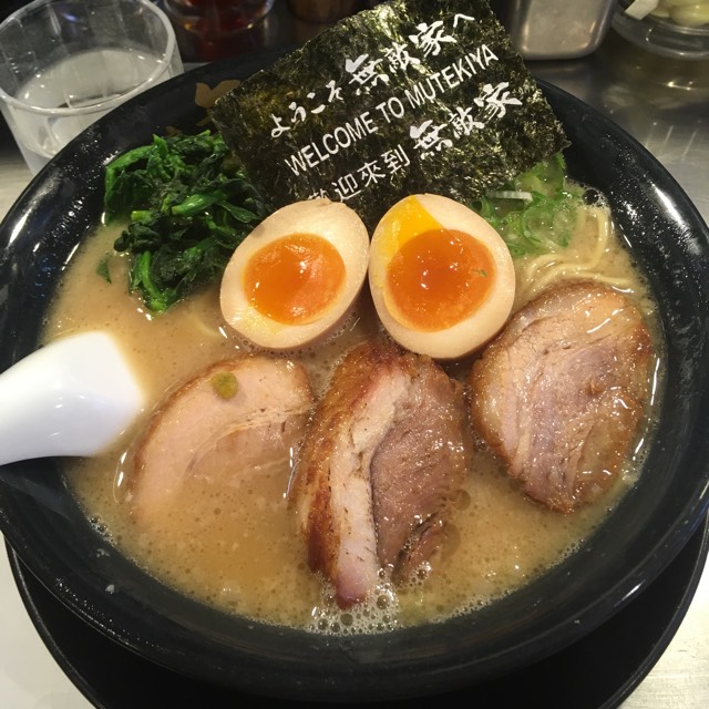 A rich bowl of Mutekiya tonkotsu ramen with thick char siu, soft eggs and 'Welcome to Mutekiya' nori