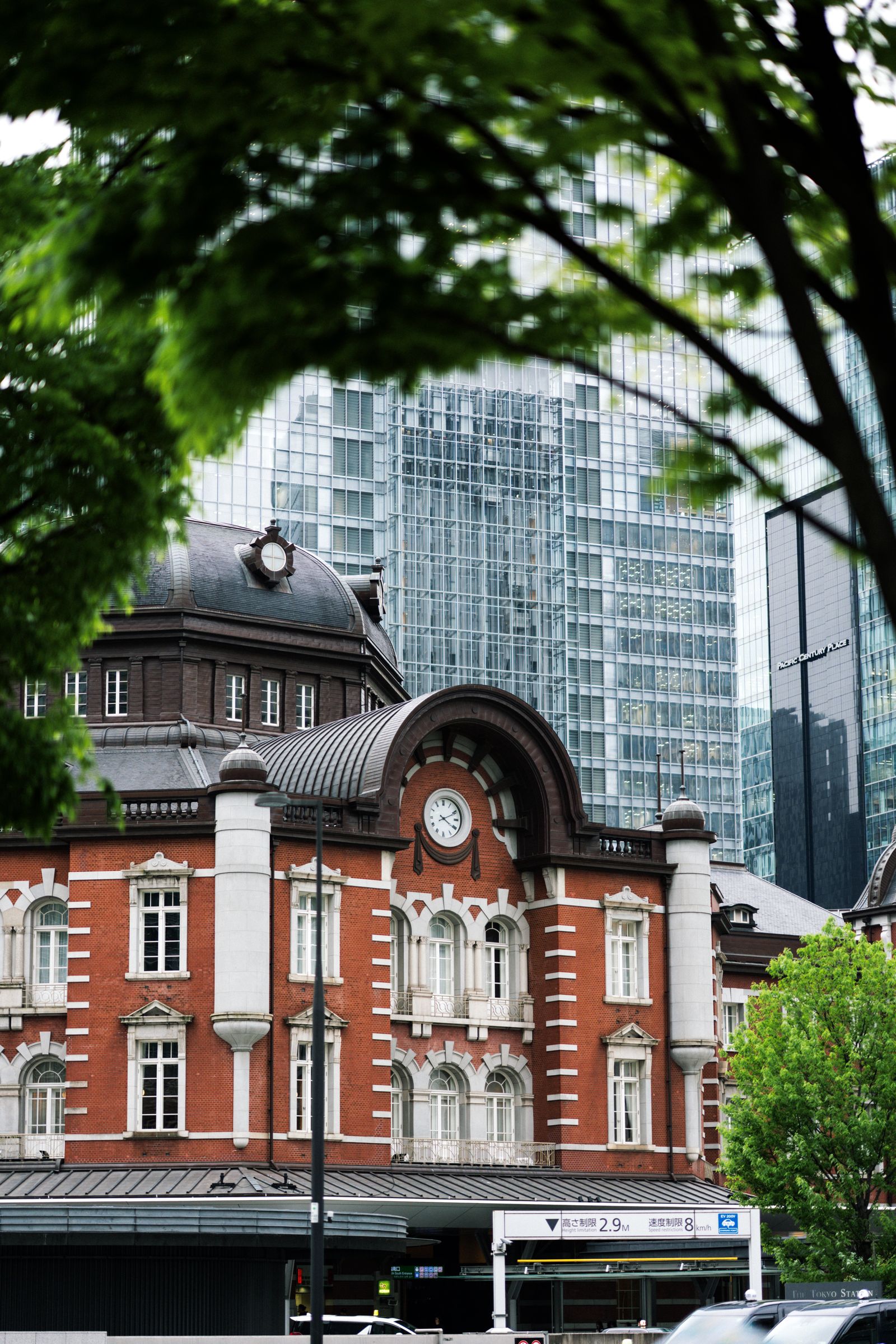 The historic red-brick Marunouchi facade of Tokyo Station against modern skyscrapers