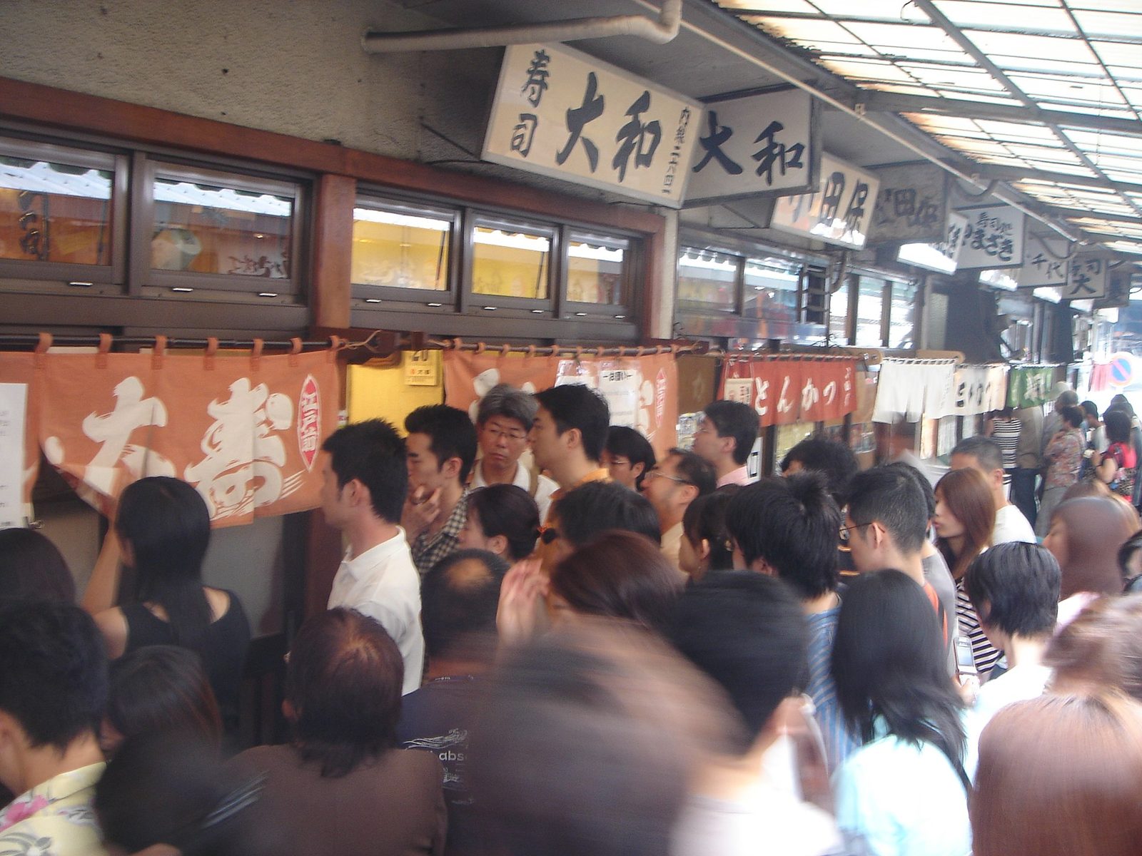 A crowd queuing outside the famous Daiwa sushi shops at Tsukiji market